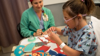 A pediatric patient plays with toys and crafts while at the hospital.