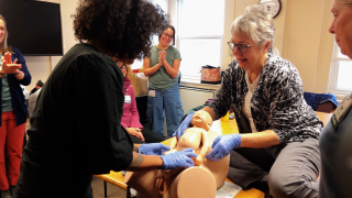 Midwives learn childbirth techniques using medical dummies.