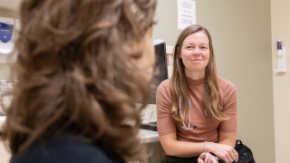 Two medical providers speak to one another.