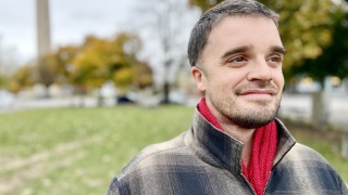 Portrait of Jonah Curtin standing outside.