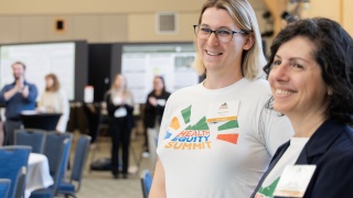 Taylor Small smiles for a photo at the Health Equity Summit in Burlington.