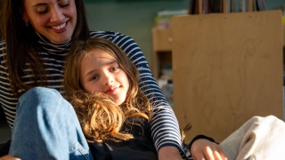 Eliza Andrews sits with her mother, Hillary, at Golisano Children's Hospital.