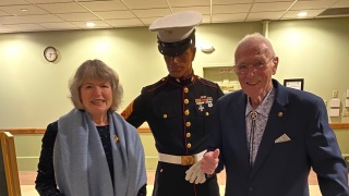 Melinda and John pose with a marine.