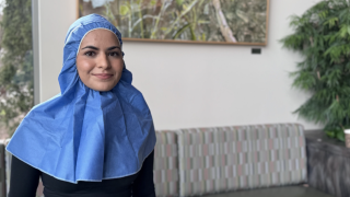 A patient wears a disposable hijab.