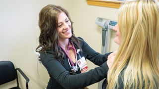 A medical provider checks a patient.