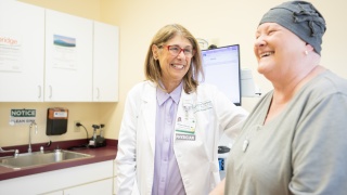 A medical provider smiles at a patient.