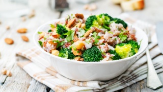 Bowl of broccoli, rice and nuts. 