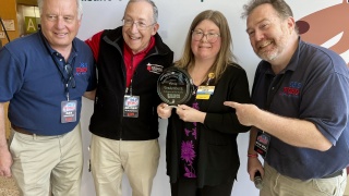 Amie Vradenburg (second from right) receive the inaugural Victory for Kids Award from Dan Dubbonnet, general manager of WOKO (far left), Dr. Lewis First, MD, chair of Pediatrics at Golisano Children’s Hospital at UVM Health (second from left), and “Wild Bill” Sargent of WOKO (far right).