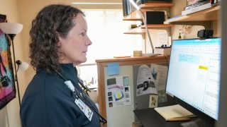 Emily Byrne, NP, reviews patient test results on a computer at Central Vermont Medical Center.