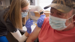 Man receiving a shot from a nurse