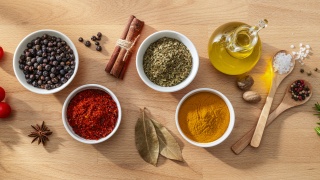 Small dishes of cooking spices and oil.