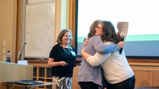 Woman hugging nurse as she receives an award