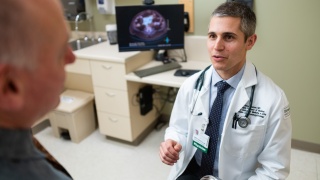 Candid portrait of Dr. Gerson speaking with patient.