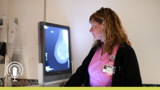 Radiology technician looking at a breast mammogram