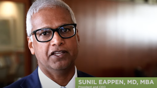 A YouTube still shows Sunil Eappen, MD, MBA, President and CEO of the UVM Health Network. 