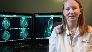 Diagnostic Radiologist Hannah Perry, MD, stands next to breast cancer imaging mammography.