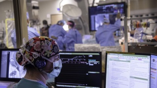 Nurse Jean Laird, RN, monitors a TAVR procedure to replace an aortic heart valve.
