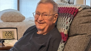 Ralph Page sits in his recliner at home.