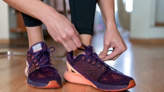 A person ties up their shoelaces.