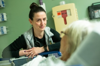 A provider talks to a patient in the University of Vermont Medical Center Emergency Department.