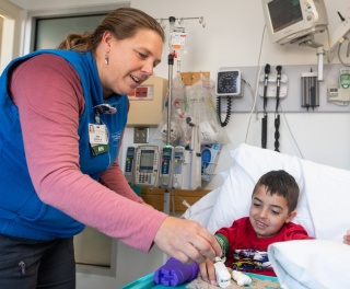 A medical provider plays with a pediatric inpatient. 