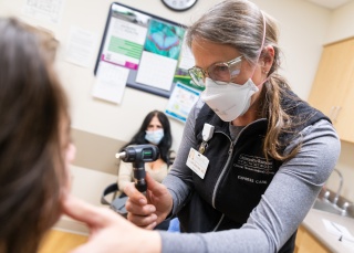 A medical provider examines a patient.