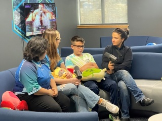 Participants sit on a sofa during the Champlain College E-Sports Event.