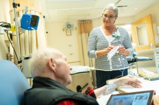 A University of Vermont Medical Center Infusion Center Shepardson 4 North nurse assists a patient.