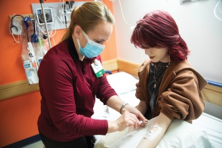 An adolescent hematology and oncology patient has her blood drawn at the University of Vermont Medical Center Childrens Hospital.