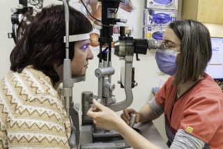 An ophthalmologist examines a patient's eyes.