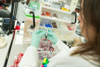 A laboratory specialist checks a sample.