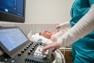 A medical provider conducts an ultrasound of a patient.