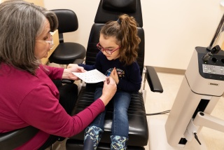 A pediatric ophthalmology patient meets with a provider at their eye care appointment..