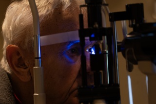 Adult patient receives an eye exam during an ophthalmology appointment at UVM Medical Center.
