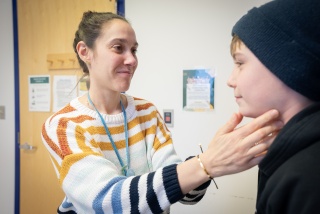 Lauren Iacono, DO, examines a pediatric patient at UVM Children’s Hospital Specialty Clinic.