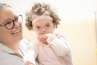 Pediatric patient Nora McDougall and her mother smile for a photo.