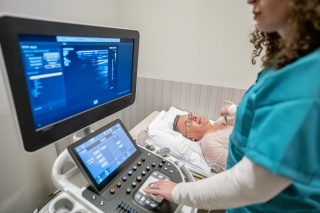 A patient receives an ultrasound on their chest. 