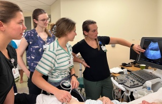 A group of GME Family Medicine residents performing an ultrasound