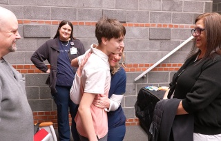 Ryan Long, 14, is greeted by Kaylee Miller, RN, and Linda Dumbuya, RN, both emergency department nurses at Champlain Valley Physician’s Hospital, before a ceremony honoring Ryan at Beekmantown Middle School on Friday, January 30, 2026. Ryan is credited with saving his grandmother’s life, Michelle Hunt (right), after she suffered a medical emergency at her home. Ryan, with the help of both nurses, sustained CPR on his grandmother for more than 7 minutes before first responders arrived.
