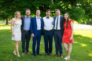 Group photo of the six Emergency Medicine 2025 alums standing outdoors.