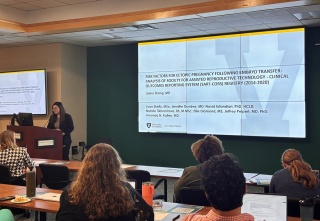 OBGYN resident presents research to a room of people.
