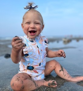 Toddler Heidi Fitzhugh plays in the sand at the beach. 