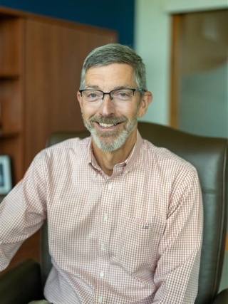 John Dwyer poses for a photo in his office.