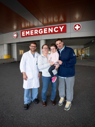 Pediatric patient Nora McDougall with her parents and physician outside of the Emergency Department at UVM Medical Center.