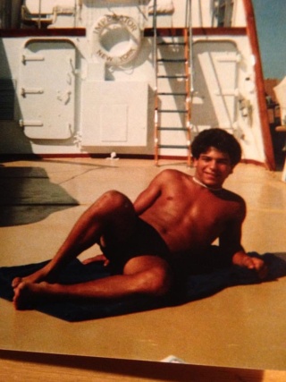 Chris Lazar poses for a photo on a yacht.