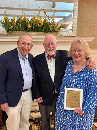 The Moseley family stand with Dr. Lewis First of Golisano Children's Hospital for a photo.