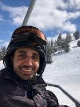 Naiim Ali, MD, FRCPC on a ski lift
