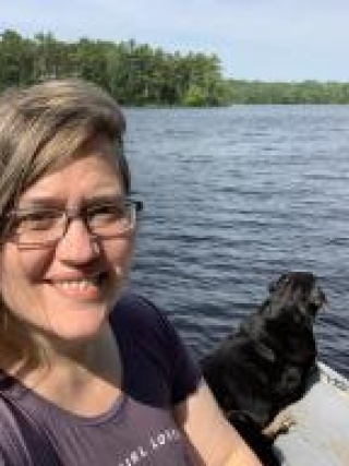 Ruth Vant with her dog on a lake