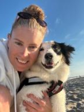 Kate Dawber takes selfie with her dog on the beach.