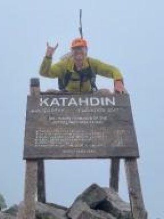 Daniel Moroney, MD on top of Katahdin trail sign